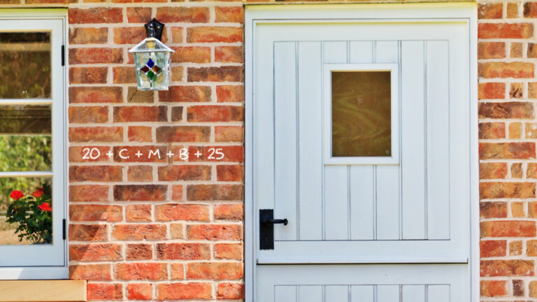Front door of cottage with marking 20+C+M+B+25